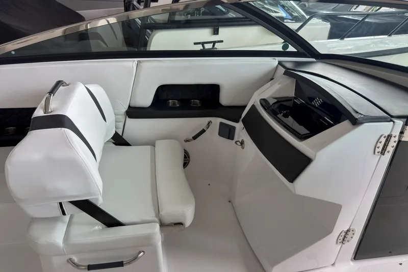Slide: The Image of Interior of 2026 Four Winns H9 OB boat with white seating and sleek dashboard design. - 8