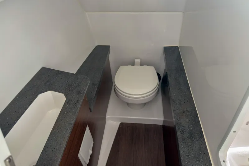 Slide: The Image of 2026 Four Winns H9 OB boat bathroom with modern sink and toilet. - 12