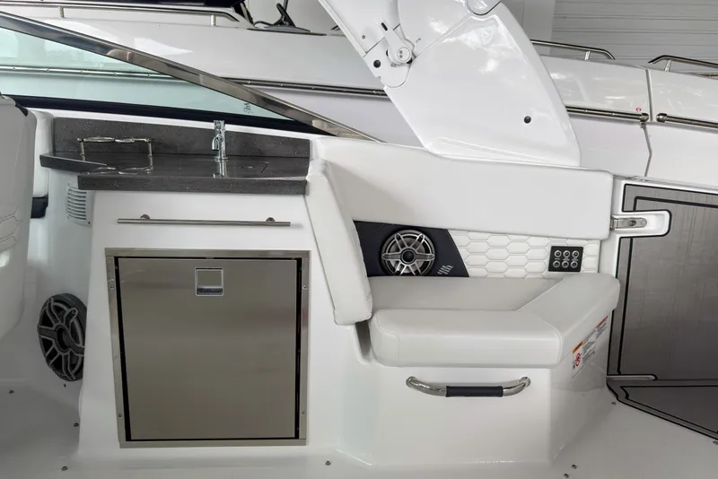 Slide: The Image of 2026 Four Winns H9 OB boat interior with seating, sink, and storage. - 17