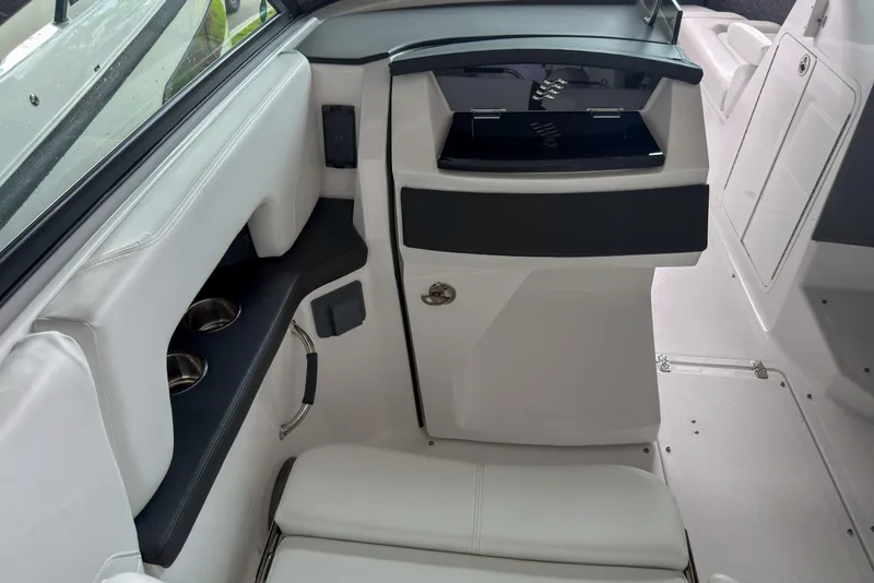Slide: The Image of Interior of 2026 Four Winns H9 OB boat, featuring sleek white seating and modern design. - 9