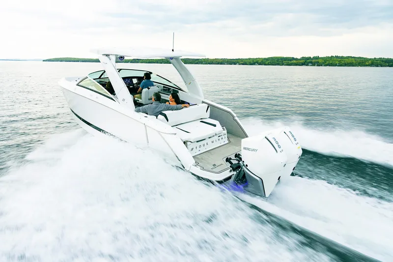 Slide: The Image of 2026 Four Winns H9 OB boat cruising on a lake with passengers onboard. - 18