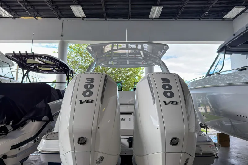 Slide: The Image of 2026 Four Winns H9 OB boat with dual 300 V8 outboard engines in showroom. - 26