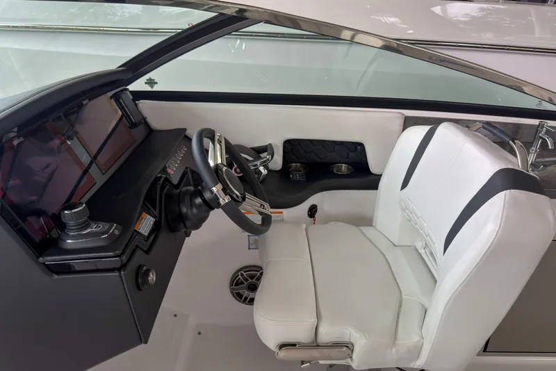 Slide: The Image of 2026 Four Winns H9 OB boat cockpit with modern steering and white seating. - 11
