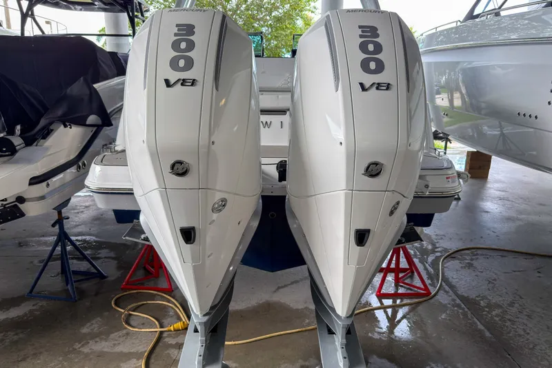 Slide: The Image of 2026 Four Winns H9 OB with twin Mercury 300 V8 outboard engines in a showroom. - 25