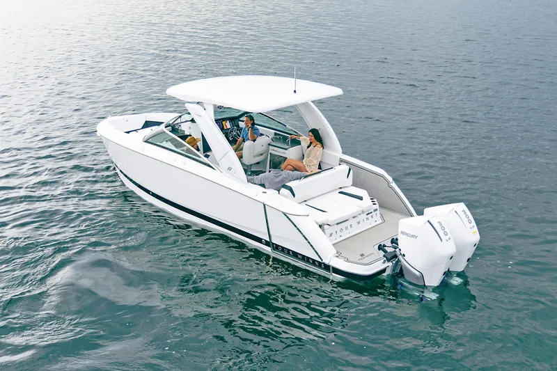 Slide: The Image of 2026 Four Winns H9 OB boat cruising on open water with passengers. - 17