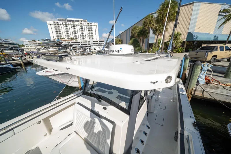 Slide: The Image of 2022 World Cat 400 CC-X boat docked at marina with clear blue sky. - 6