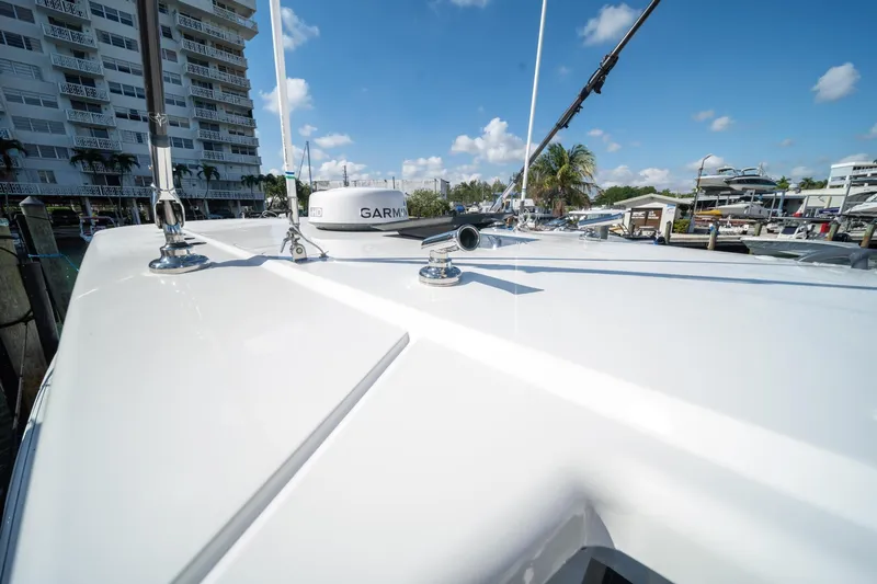 Slide: The Image of 2022 World Cat 400 CC-X boat deck with Garmin equipment, docked near waterfront buildings. - 8
