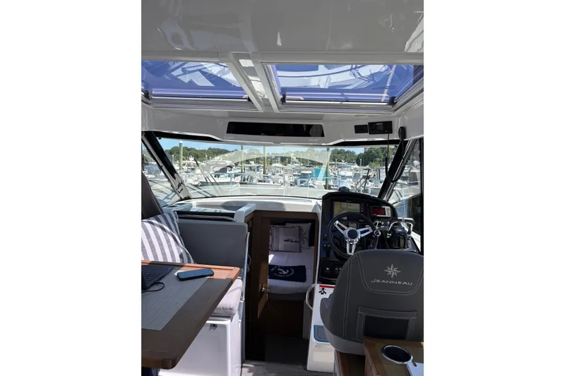 Slide: The Image of Interior view of 2020 Jeanneau NC 895 boat with helm and seating area. - 11