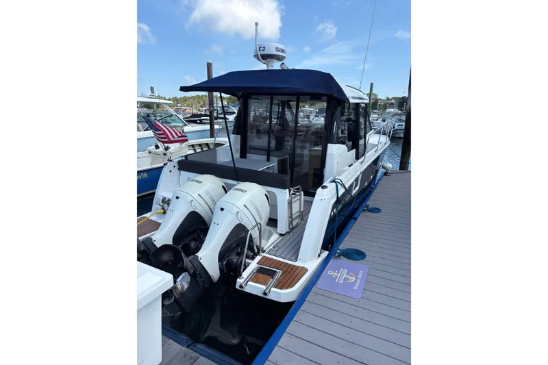Slide: The Image of 2020 Jeanneau NC 895 boat docked, featuring twin Yamaha outboard engines. - 5