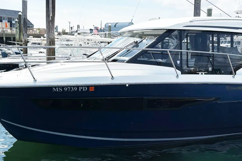 Slide: The Image of 2020 Jeanneau NC 895 boat docked in marina, side view with registration number. - 2