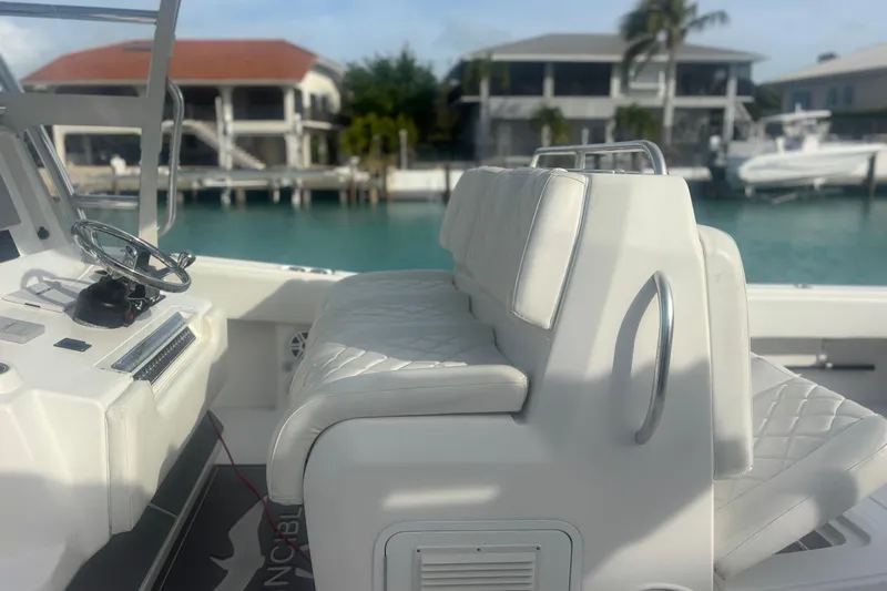 Slide: The Image of 2017 Invincible 39 Open Fisherman boat interior with white seating and steering wheel. - 6