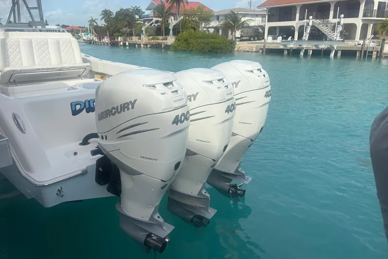 Slide: The Image of 2017 Invincible 39 Open Fisherman with triple Mercury 400 outboard engines docked in turquoise water. - 12