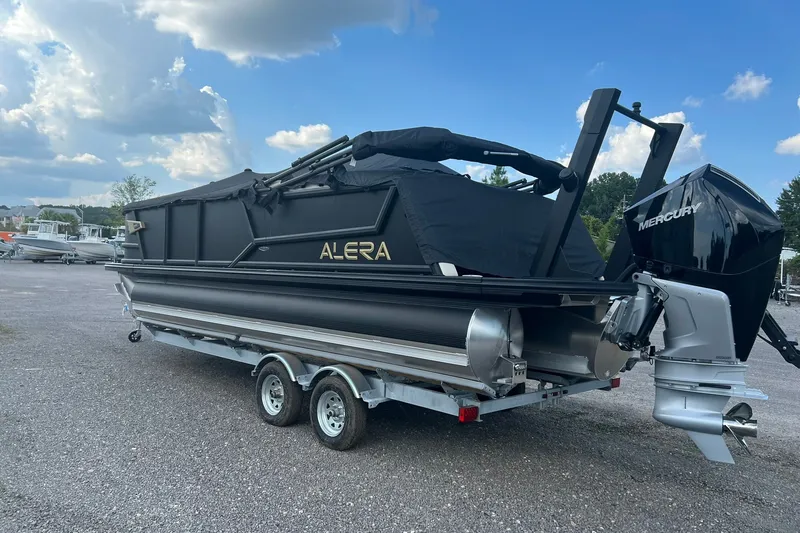 Slide: The Image of 2026 Alera M 23Q pontoon boat on trailer with Mercury outboard motor. - 2