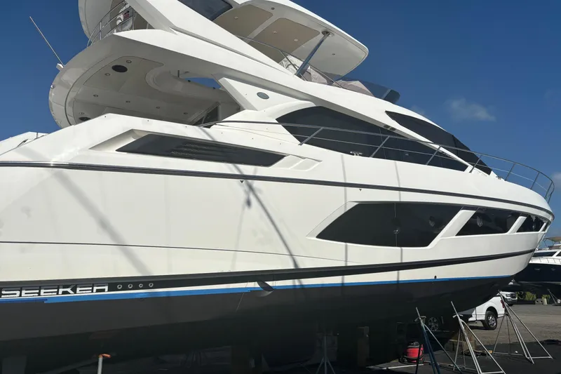 Slide: The Image of 2016 Sunseeker Manhattan 65 yacht, sleek design, docked under clear blue sky. - 26