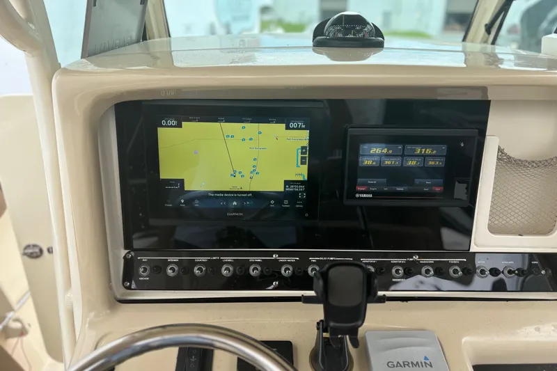 Slide: The Image of 2013 Scout 275 LXF dashboard with Garmin navigation and Yamaha display. - 16