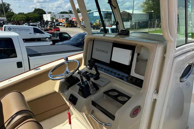 Slide: The Image of 2013 Scout 275 LXF boat dashboard with Garmin navigation system and steering wheel. - 13