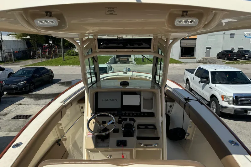 Slide: The Image of 2013 Scout 275 LXF boat interior with Garmin navigation system and steering wheel. - 12