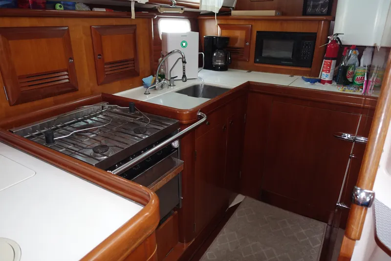 Slide: The Image of Galley kitchen in 2001 Beneteau Oceanis 461 yacht with stove, sink, and microwave. - 40