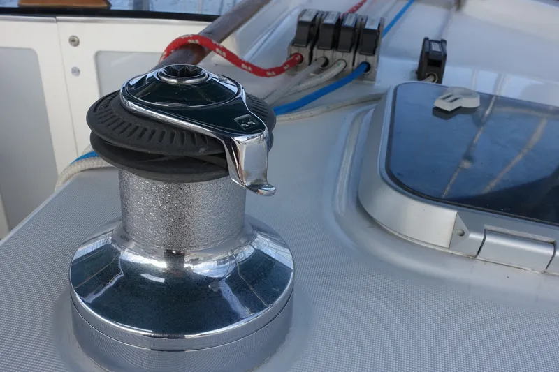 Slide: The Image of Winch on 2001 Beneteau Oceanis 461 sailboat deck, with ropes and hatch visible. - 21