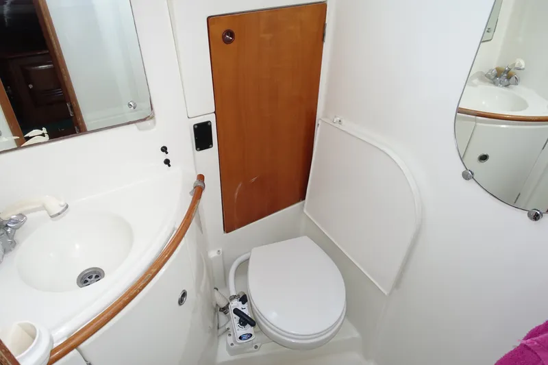 Slide: The Image of Bathroom interior of 2001 Beneteau Oceanis 461 yacht, featuring sink, toilet, and mirror. - 31