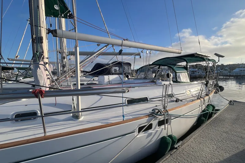 Slide: The Image of 2001 Beneteau Oceanis 461 sailboat docked at marina under clear blue sky. - 58