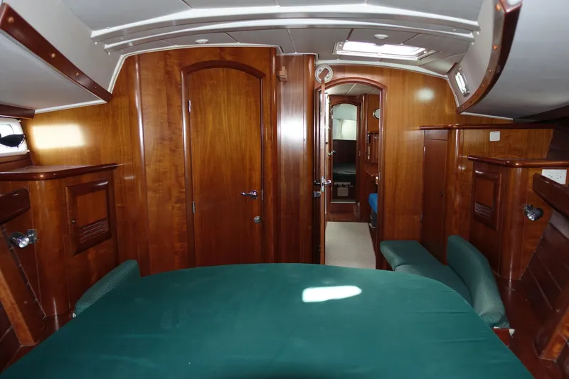 Slide: The Image of Interior of 2001 Beneteau Oceanis 461 yacht with wooden finish and green seating. - 28