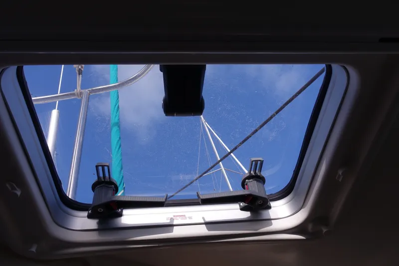 Slide: The Image of View through hatch of 2001 Beneteau Oceanis 461 sailboat, showing mast and blue sky. - 25