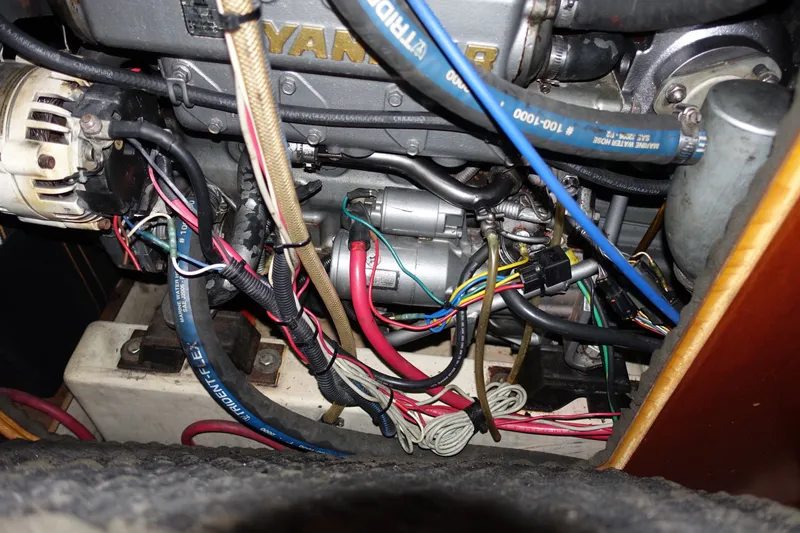Slide: The Image of Engine compartment of a 2001 Beneteau Oceanis 461 sailboat, showing wiring and hoses. - 51