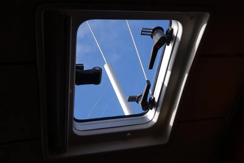 Slide: The Image of Hatch view from 2001 Beneteau Oceanis 461 sailboat, showing blue sky and mast. - 22