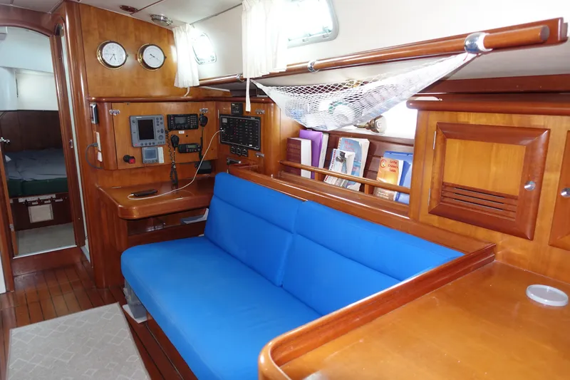 Slide: The Image of Interior of 2001 Beneteau Oceanis 461 yacht with blue seating and navigation equipment. - 33