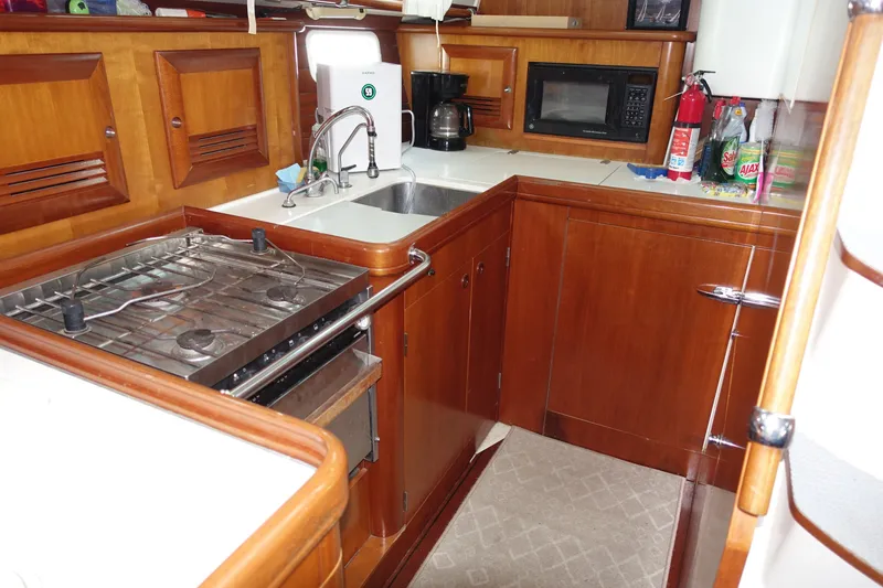Slide: The Image of Galley kitchen in 2001 Beneteau Oceanis 461 yacht with stove, sink, and microwave. - 41
