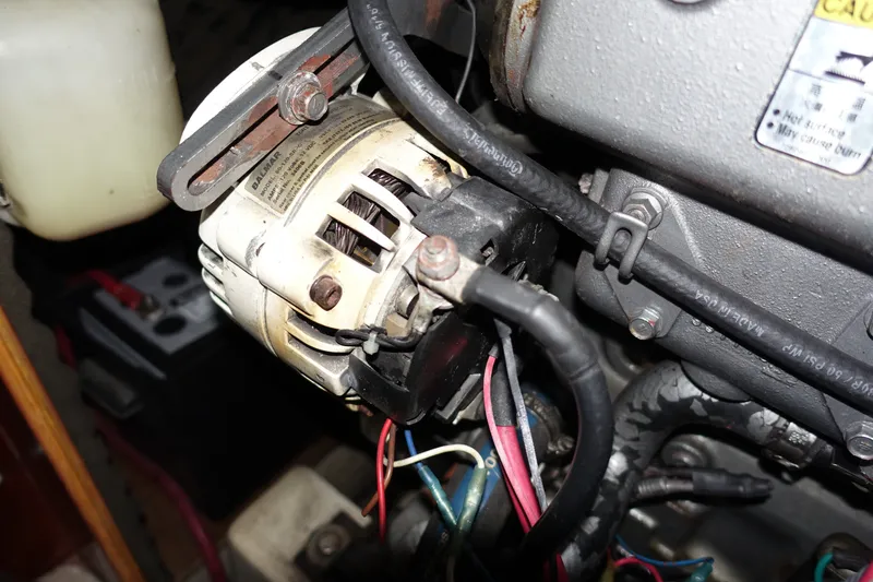 Slide: The Image of Engine compartment of a 2001 Beneteau Oceanis 461 sailboat, featuring alternator and wiring. - 50