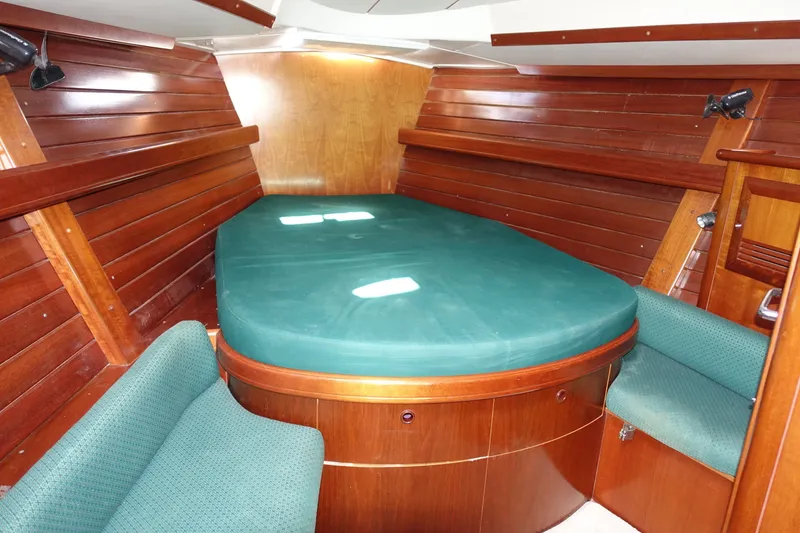 Slide: The Image of Luxurious cabin interior of 2001 Beneteau Oceanis 461 sailboat with green upholstery. - 29
