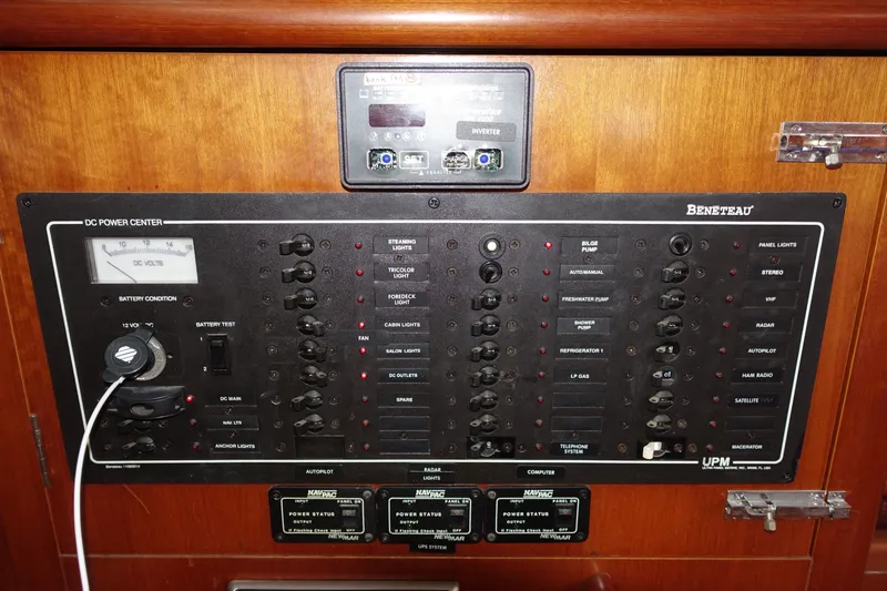 Slide: The Image of Control panel of a 2001 Beneteau Oceanis 461 sailboat, featuring various switches and gauges. - 49