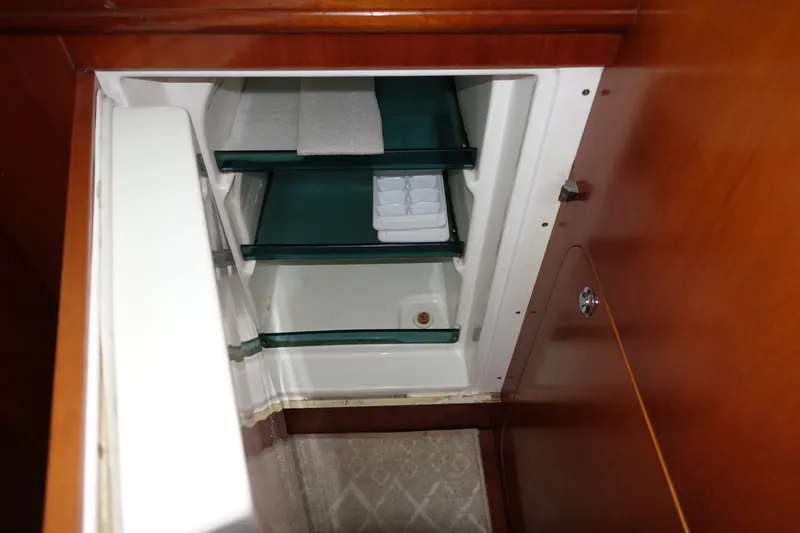 Slide: The Image of Interior view of a 2001 Beneteau Oceanis 461 yacht refrigerator with shelves and ice tray. - 43