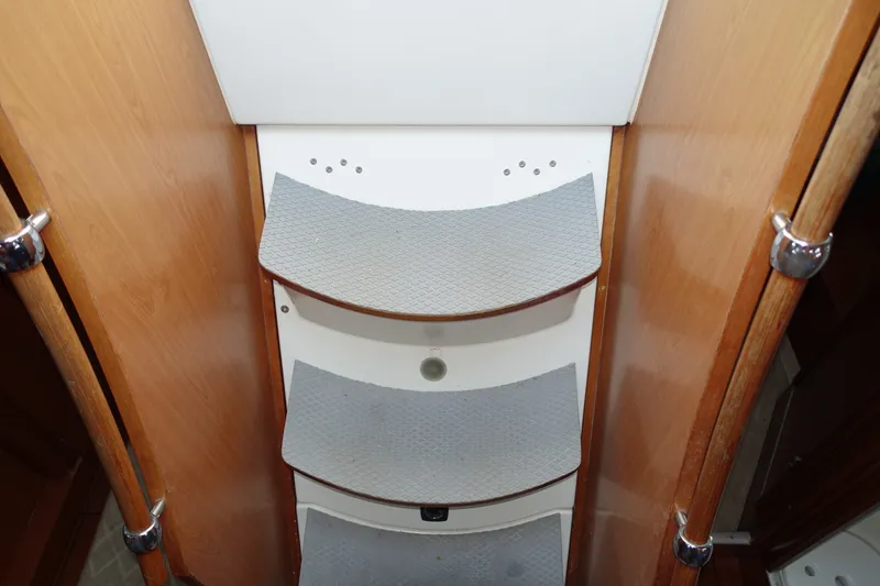 Slide: The Image of Staircase inside 2001 Beneteau Oceanis 461 yacht with wooden finish and non-slip steps. - 53