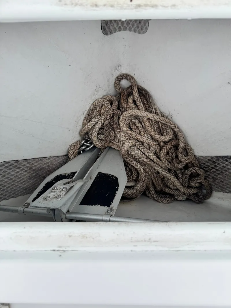 Slide: The Image of An anchor with rope in a storage compartment of a boat. - 19