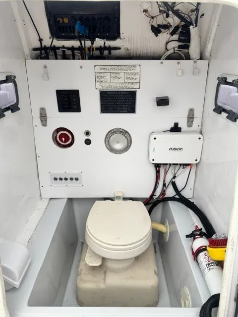 Slide: The Image of Interior view of a boat with a toilet, control panel, and fire extinguisher. - 16