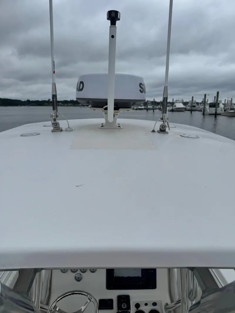 Slide: The Image of The boat is a 2005 Topaz 24, featuring a radar on the roof. - 20