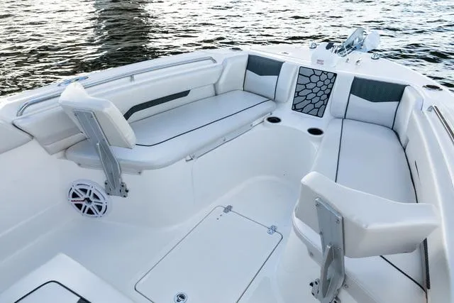 Slide: The Image of 2023 Wellcraft 222F boat interior with white seating and modern design on water. - 16