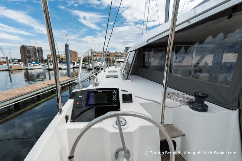 Slide: The Image of 2019 Nautitech 40 Open yacht cockpit with navigation system, docked at marina. - 28