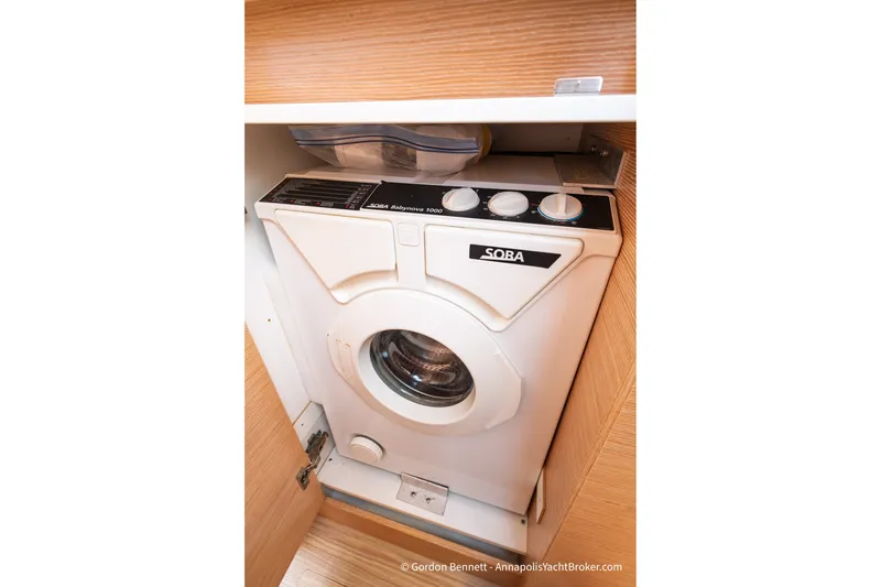 Slide: The Image of Compact washing machine in Nautitech 40 Open yacht, 2019 model, wooden cabinet setting. - 58