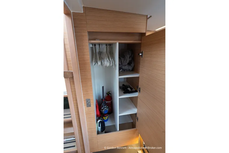 Slide: The Image of Wooden closet interior on 2019 Nautitech 40 Open yacht, featuring shelves and hangers. - 50