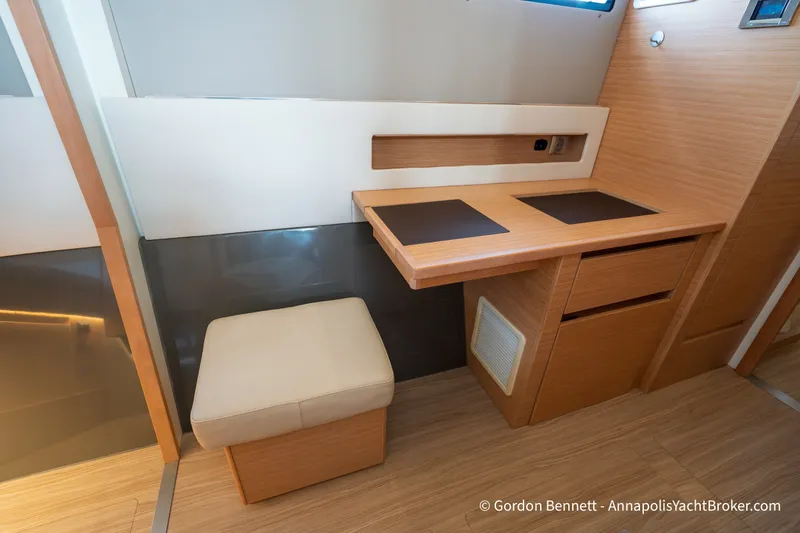Slide: The Image of Interior of 2019 Nautitech 40 Open yacht with wooden desk and cushioned stool. - 46