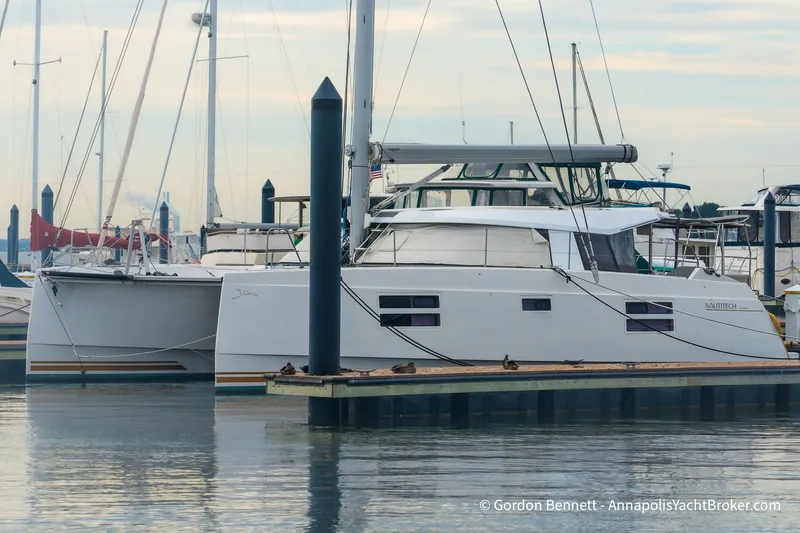 The Image of 2019 Nautitech 40 Open catamaran docked at a marina, showcasing sleek design and modern features. - 0