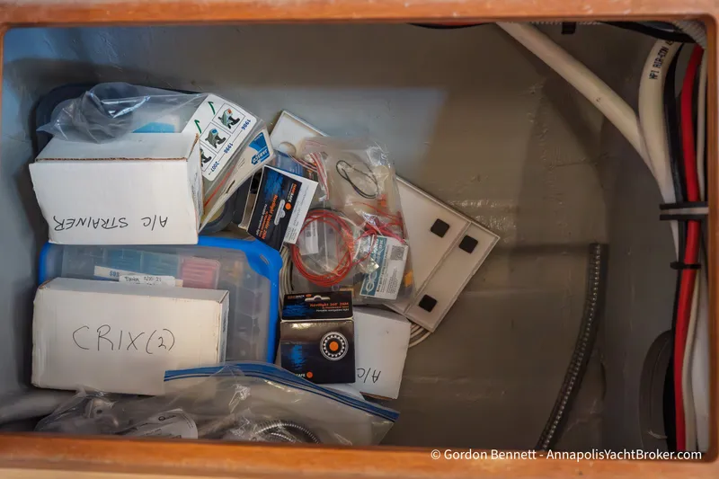 Slide: The Image of Storage compartment with various boxes and cables on a 2019 Nautitech 40 Open yacht. - 67