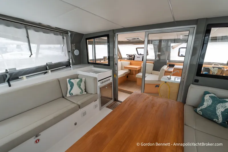 Slide: The Image of Interior of 2019 Nautitech 40 Open catamaran, featuring modern seating and wooden table. - 33