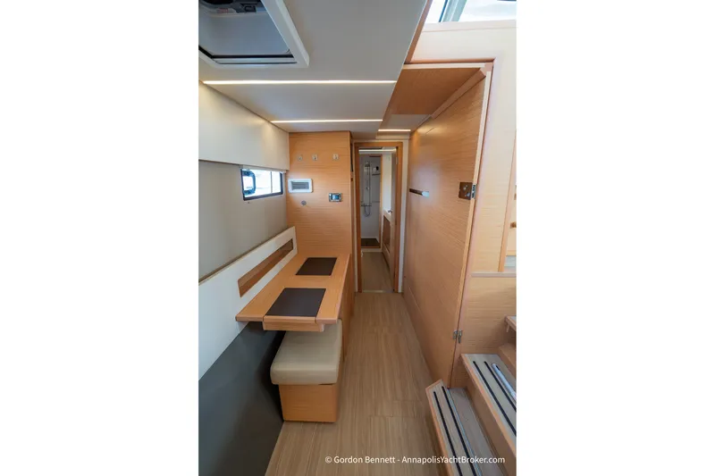 Slide: The Image of Interior of 2019 Nautitech 40 Open yacht, featuring modern wood finishes and seating area. - 45