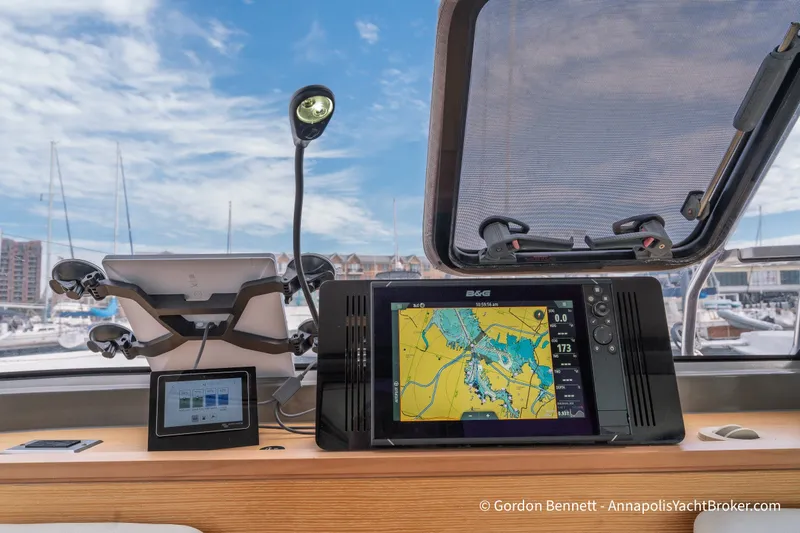 Slide: The Image of Cockpit of 2019 Nautitech 40 Open with navigation equipment and marina view. - 39