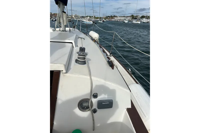 Slide: The Image of 1976 Sabre 28 sailboat deck with winch, moored in a marina. - 16
